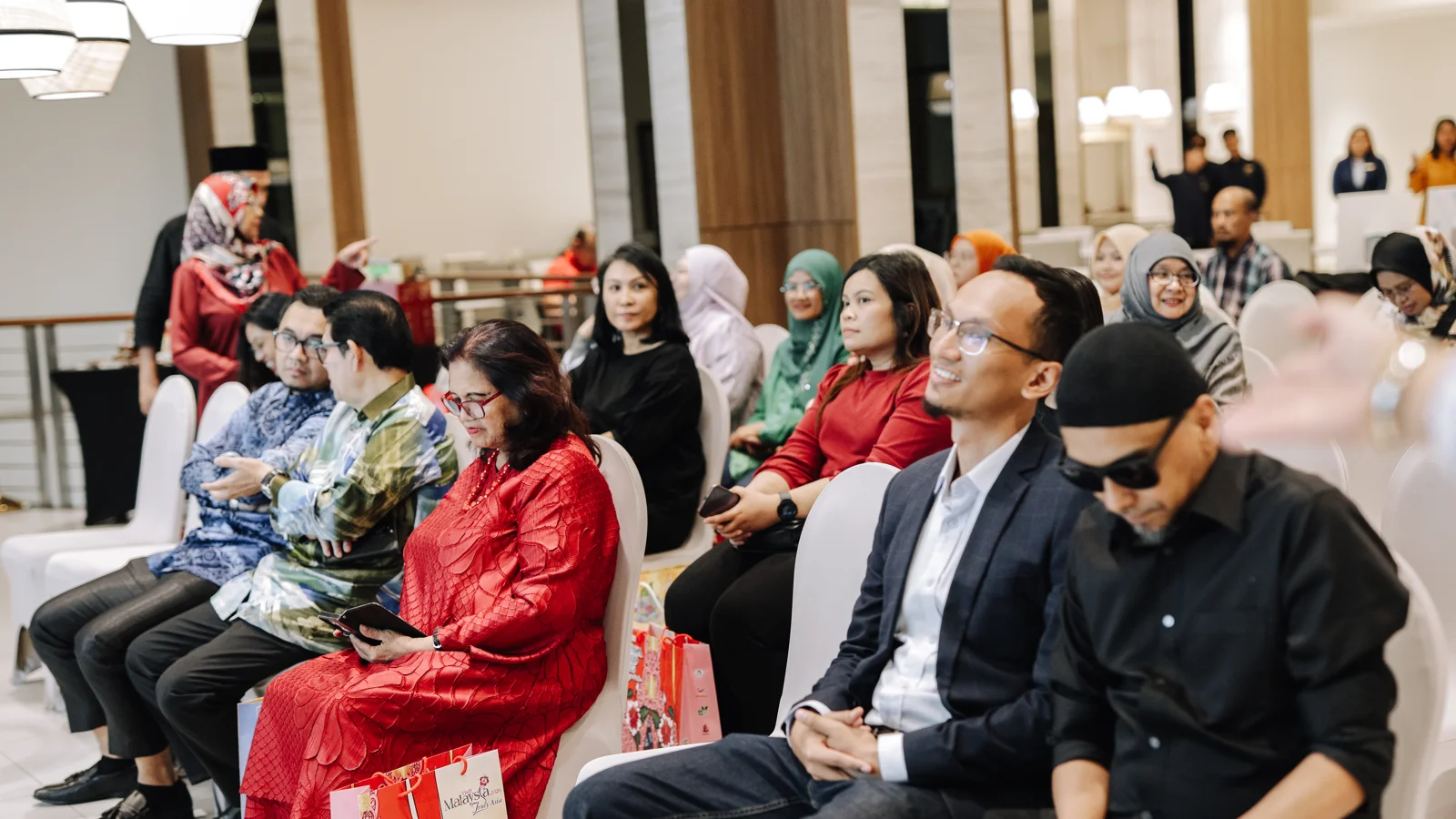 Huzaifah Za'ba seated among the audience at an event
